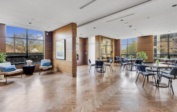 Open party room with seating and tables on a herringbone floor at 21 Clairtrell
