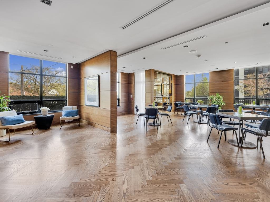 Open party room with seating and tables on a herringbone floor at 21 Clairtrell