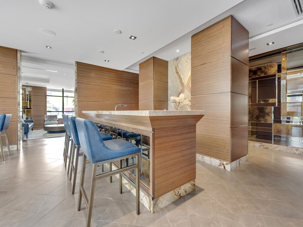 Stone-topped bar with blue stools and wood panelling at 21 Clairtrell
