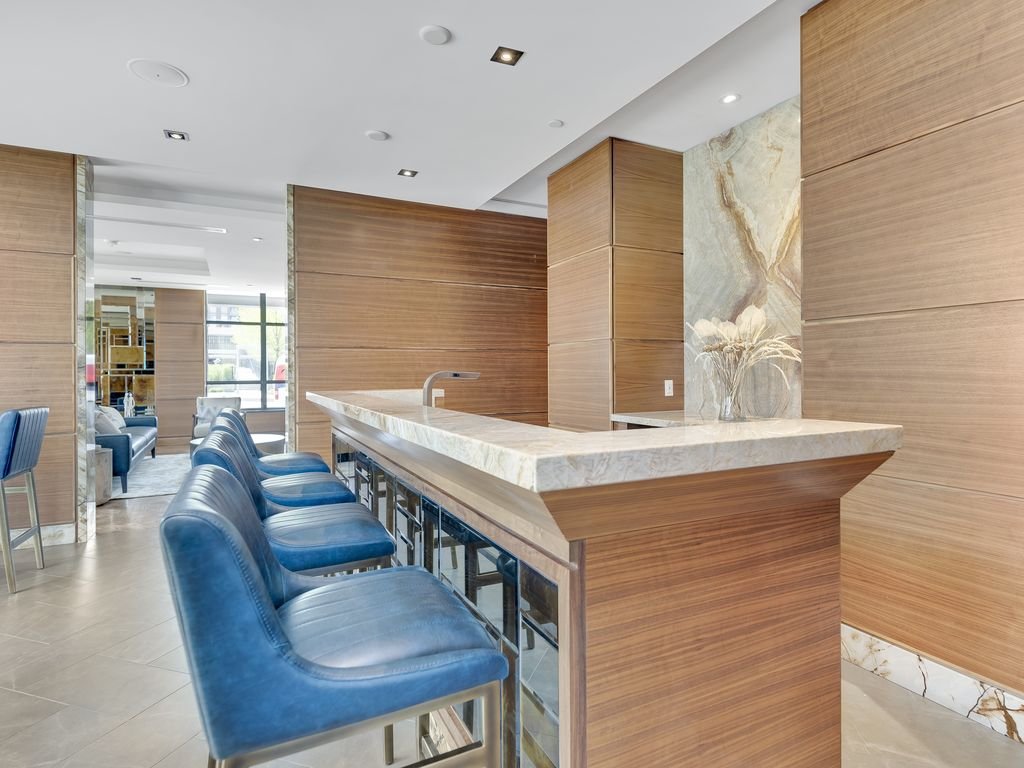 Bar counter and blue stools with a marble feature wall at 21 Clairtrell
