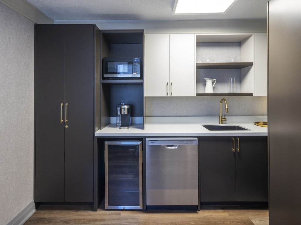 Close view of the new 250 Queens Quay kitchenette with wine fridge, dishwasher and gold cabinet handles