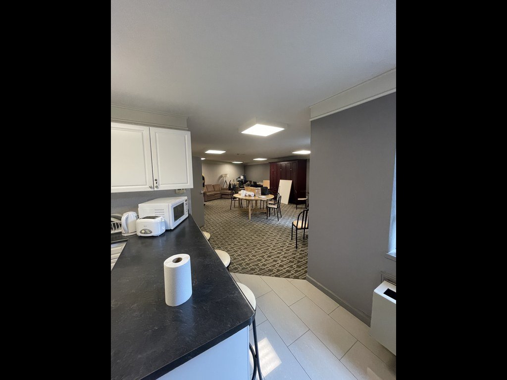 Old kitchen counter and party room beyond at 250 Queens Quay before renovation