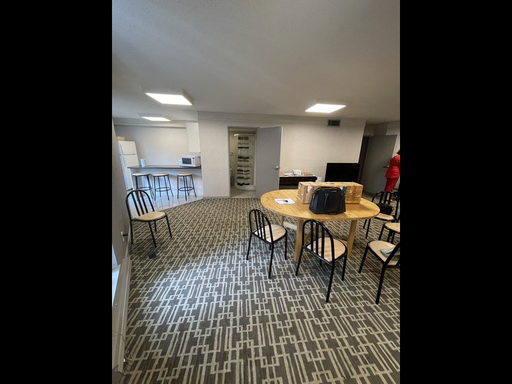 Party room at 250 Queens Quay before renovation with dining chairs and geometric carpet